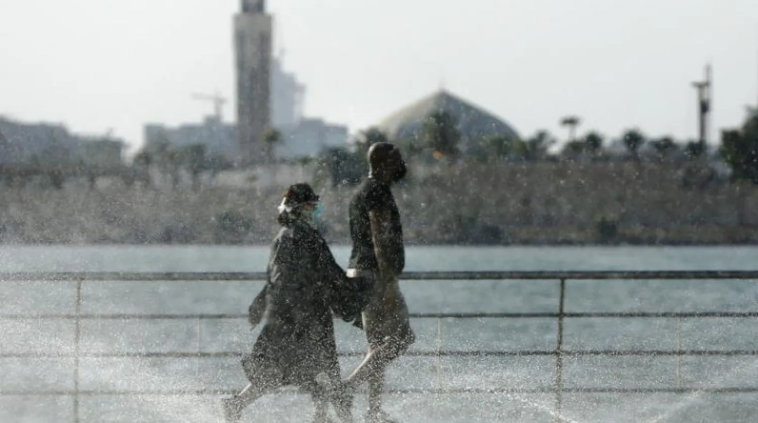 Vacationers walk while wearing face masks to help prevent the spread of the coronavirus in Jeddah, Saudi Arabia, Thursday, July 9, 2020. (AP Photo/Amr Nabil)