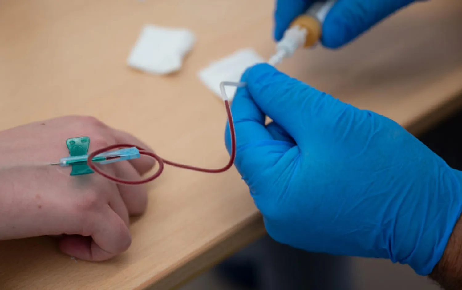 سحب عينة دم من إحدى المتطوعات من أجل دراسة على الأجسام المضادة في ألمانيا (د.ب.أ)