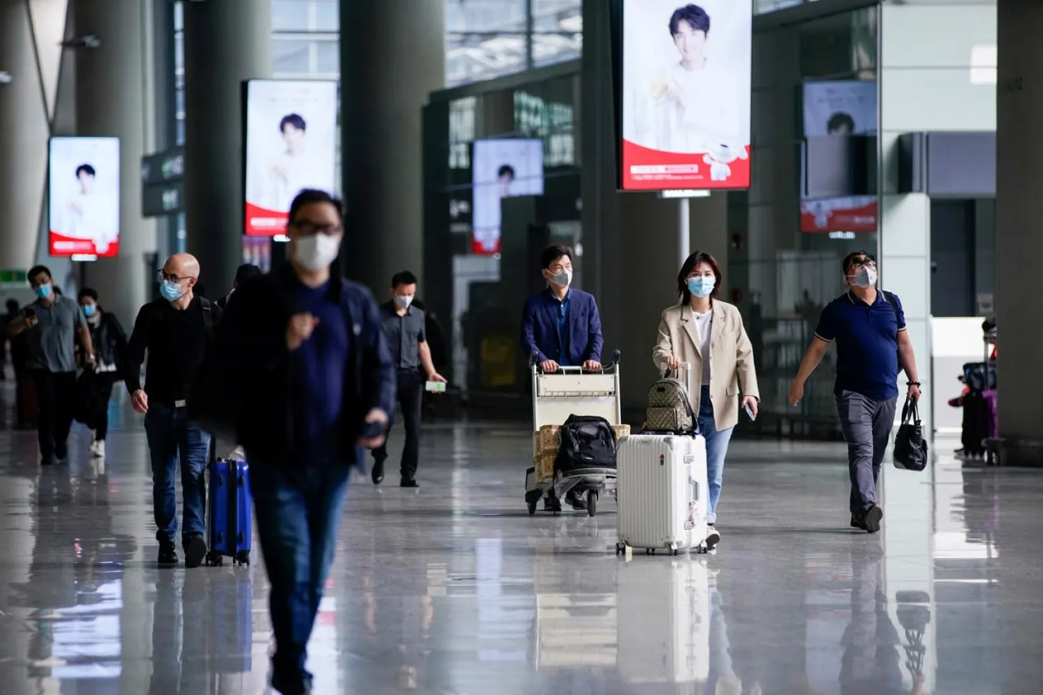 People wearing face masks are seen at Hongqiao International Airport in Shanghai, following the coronavirus outbreak, China May 21, 2020. (Reuters)