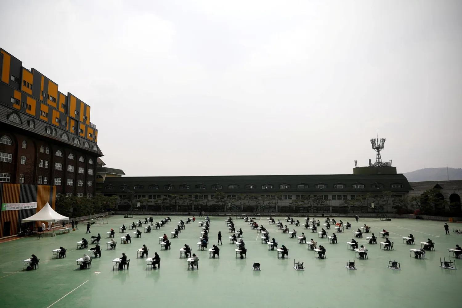South Korean job seekers attend an exam conducted outdoors amid social distancing measures to avoid the spread of the novel coronavirus, in Seoul, South Korea, April 25, 2020. (Reuters)