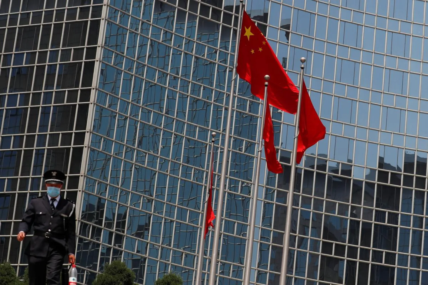 A security guard walks near the Chinese national flag in Beijing, China April 29, 2020. (Reuters)