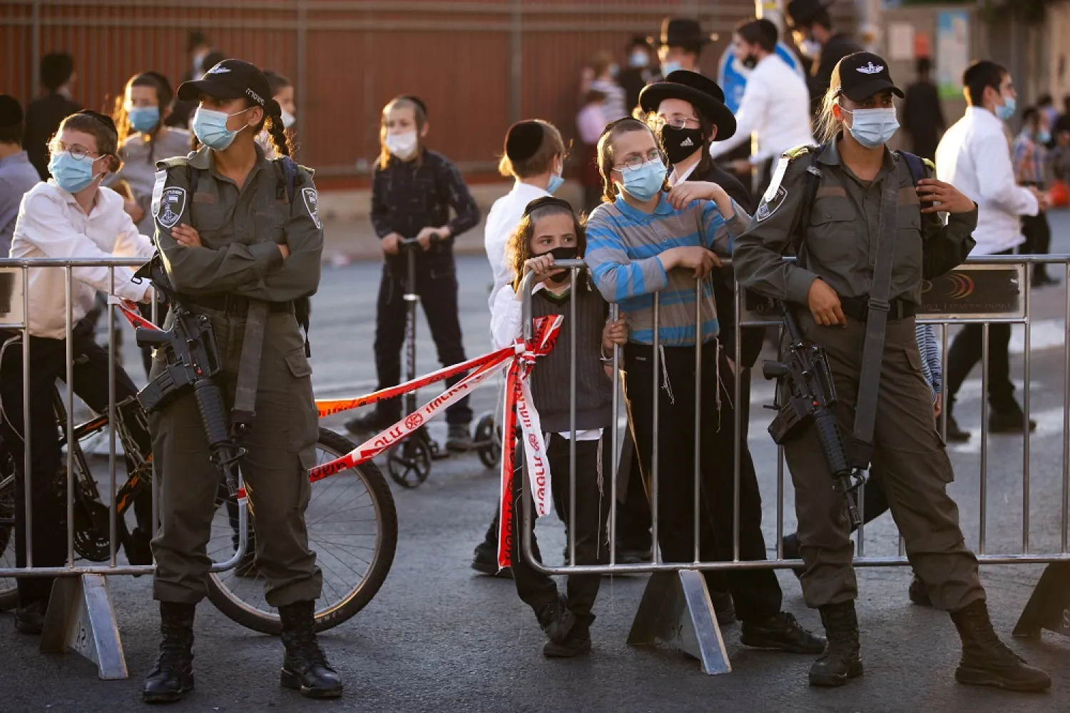 Border Police officers at a roadblock as ultra-Orthodox Jews gather for a protest against a lockdown in their neighborhood due to a coronavirus outbreak, in Jerusalem, July 13, 2020 (AP)