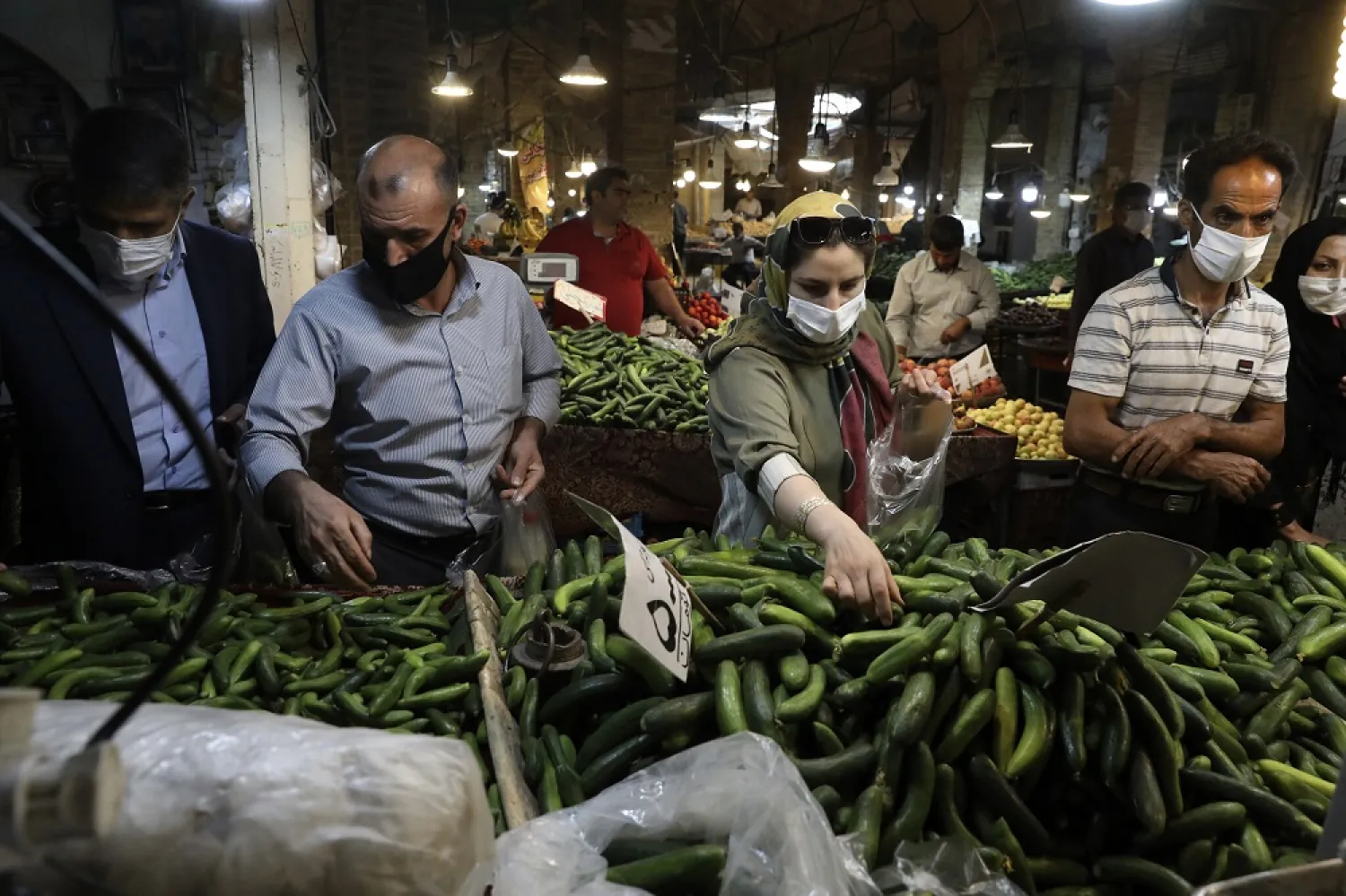 People wearing face masks to help prevent the spread of the coronavirus shop at the old grand bazaar of the Iranian city of Zanjan on July 5, 2020. (AP)
