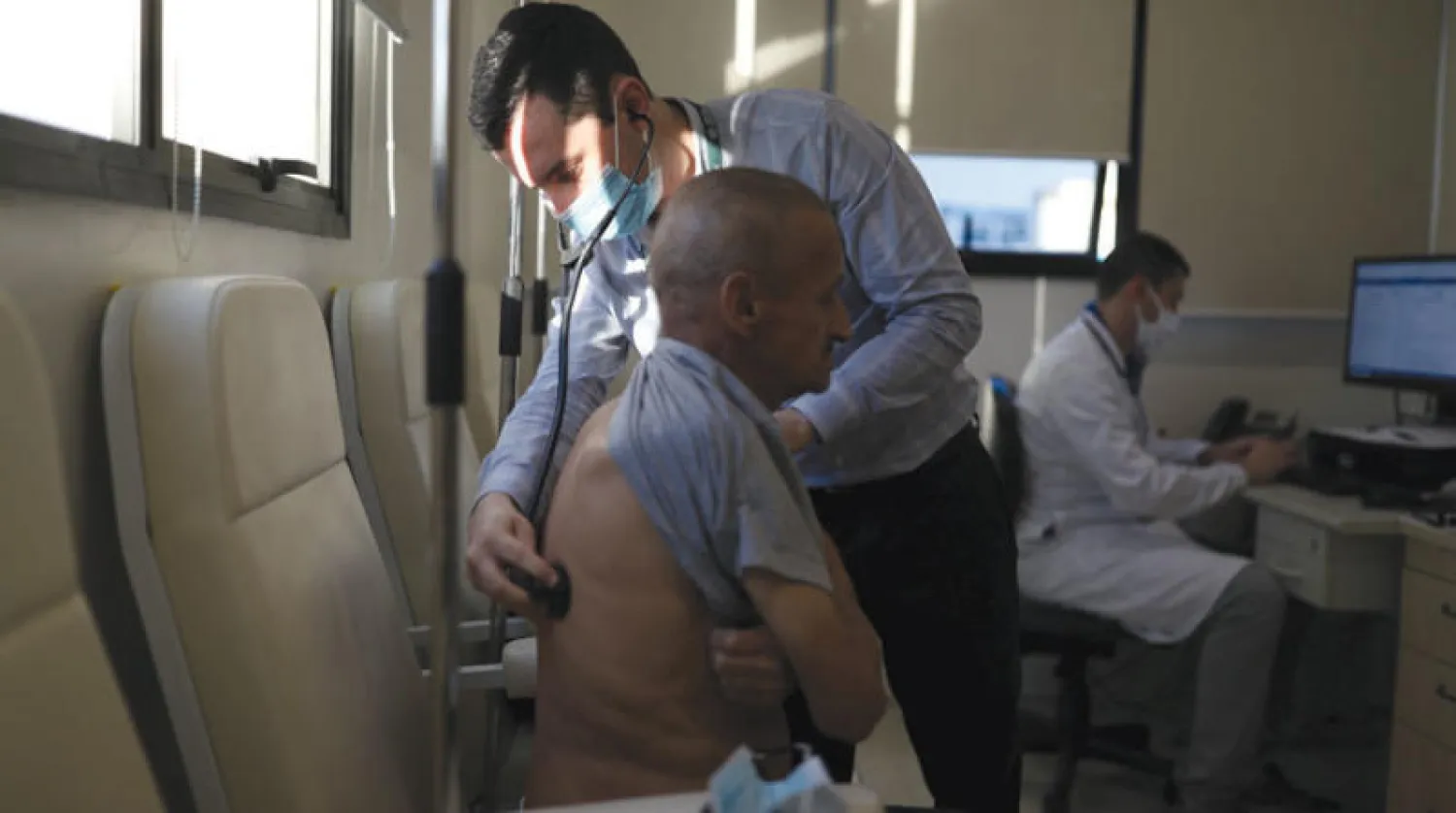 طبيب يتفقد أحد المتطوعين في برنامج لقاح «أكسفورد» التجريبي بساو باولو الخميس الماضي (رويترز)