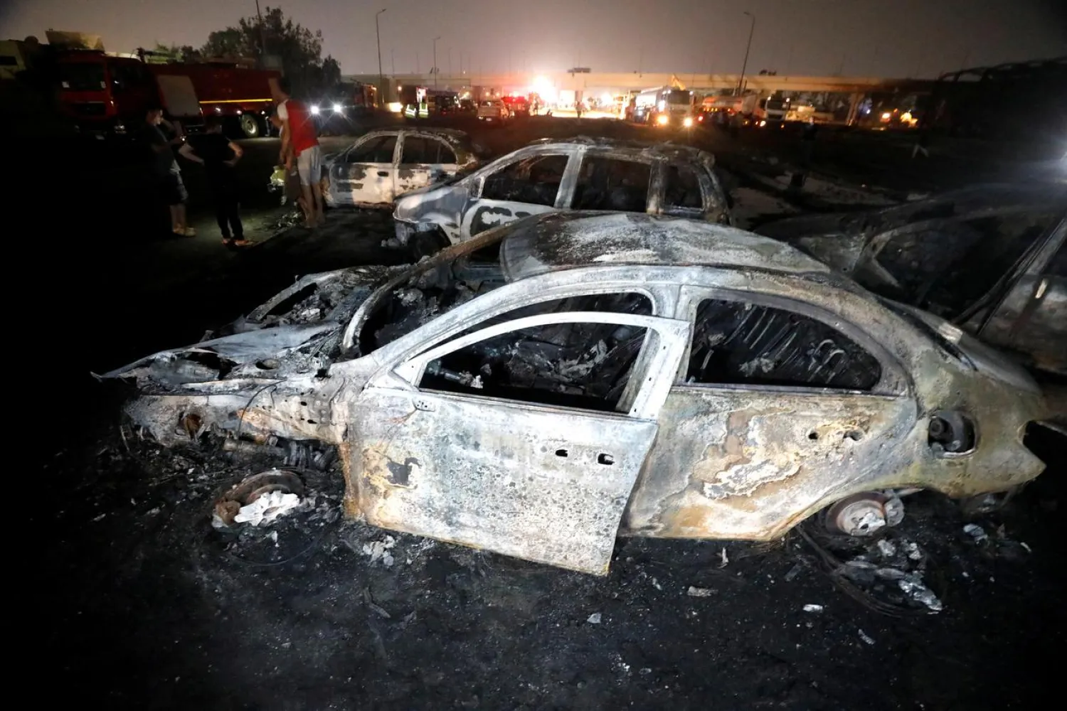 Burned vehicles are seen following a fire that broke out in Egypt's Shuqair-Mostorod crude oil pipeline, at the beginning of Cairo-Ismailia road, Egypt July 14, 2020. (Reuters)