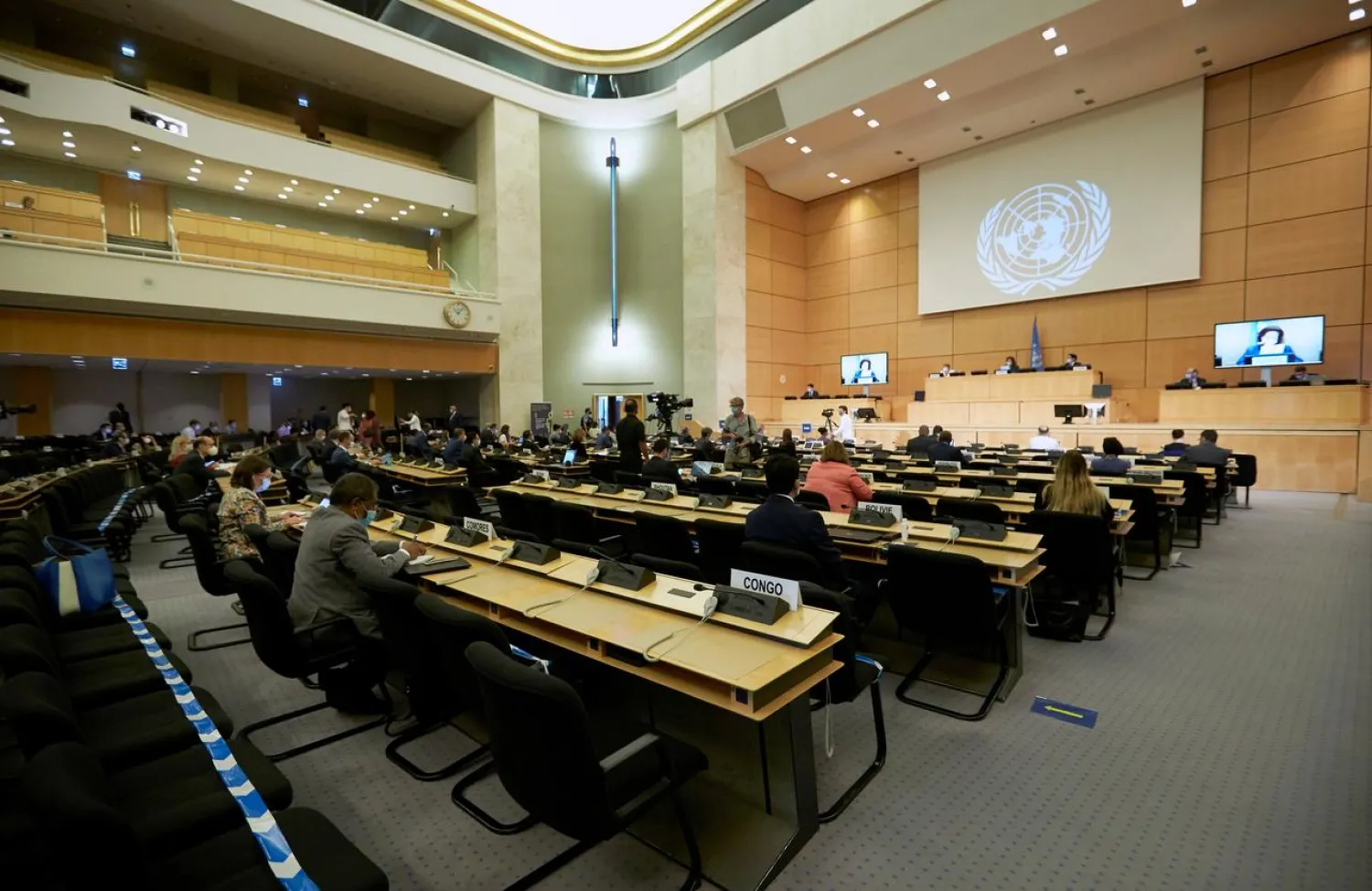 Delegates wearing protective face masks attend the 44th session of the Human Rights Council at the European headquarters of the United Nations in Geneva, Switzerland, June 30, 2020. REUTERS/Denis Balibouse