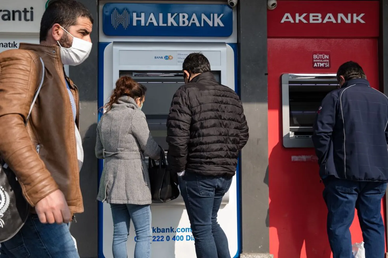 Customers use automatic teller machines in Istanbul. Photographer: Kerem Uzel/Bloomberg