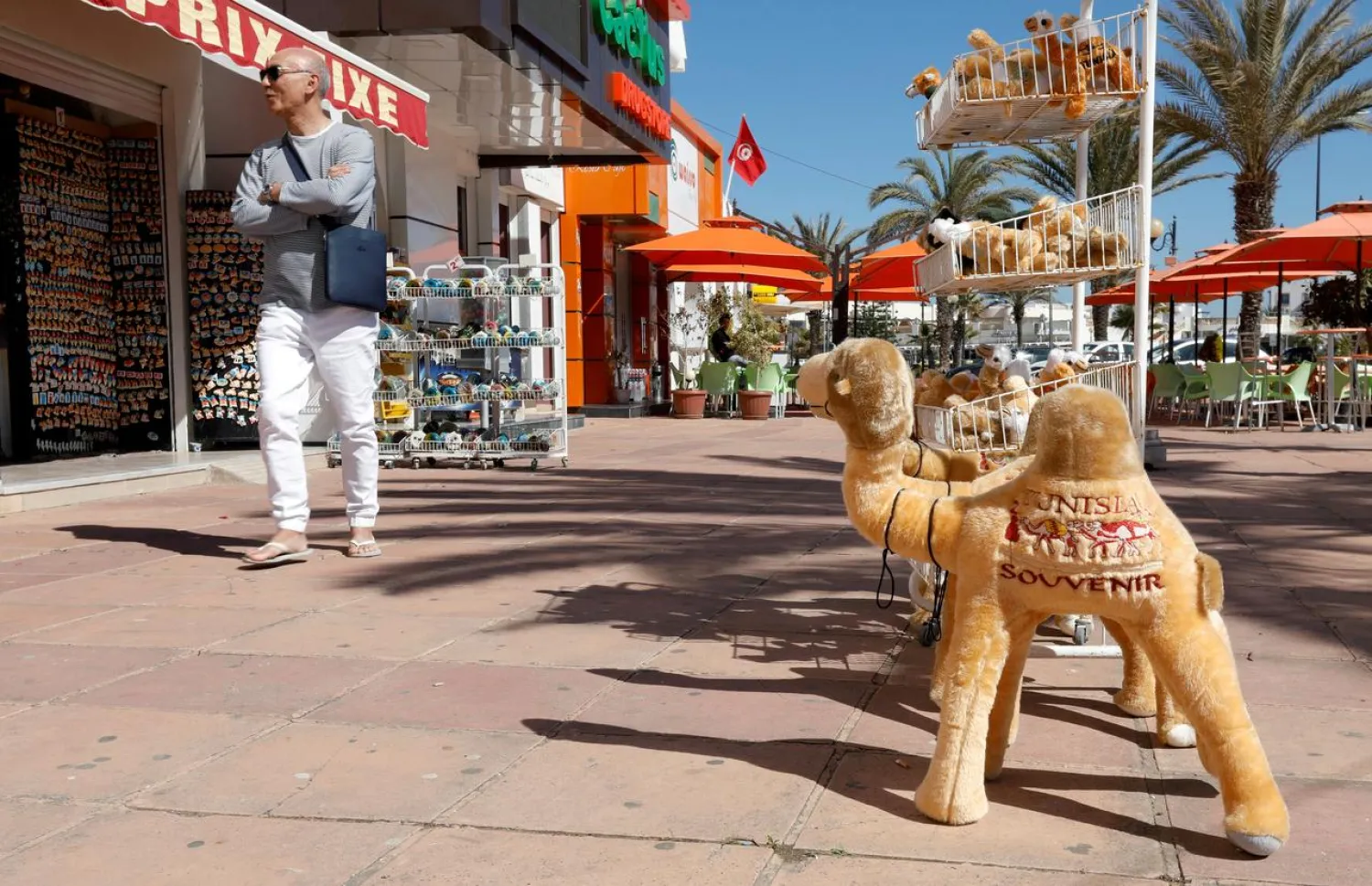 A tourist walks past a souvenir shop in Hammamet, Tunisia March 12, 2020. (Reuters)