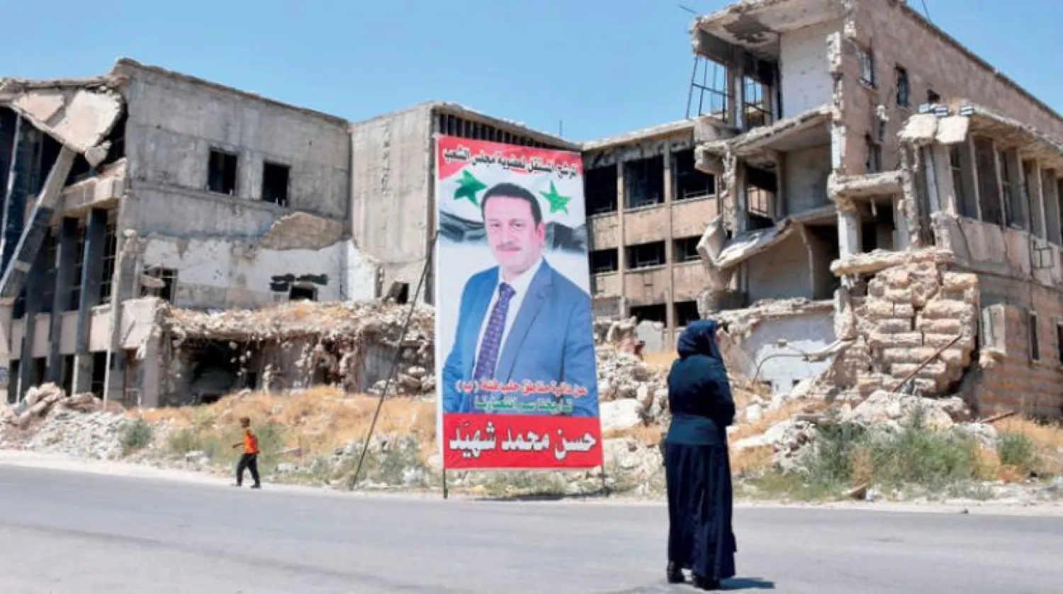 A campaign poster for the upcoming Syrian parliamentary election is displayed in the northern city of Aleppo, on July 15, 2020. (Photo by - / AFP)