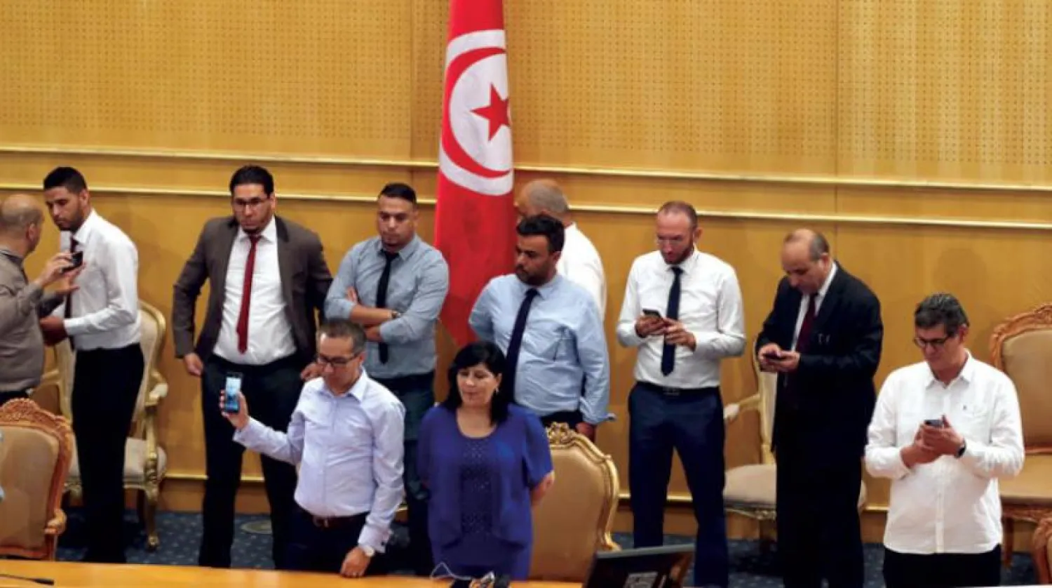 Leader of the Free Destour Party (PDL) Abir Moussi (C) is seen on the platform reserved for the President of the Parliament to prevent Rached Ghannnouchi from presiding over the election of the members of the Constitutional Court at the Parliament in Tunis, Tunisia, 16 July 2020. EPA/MOHAMED MESSARA
