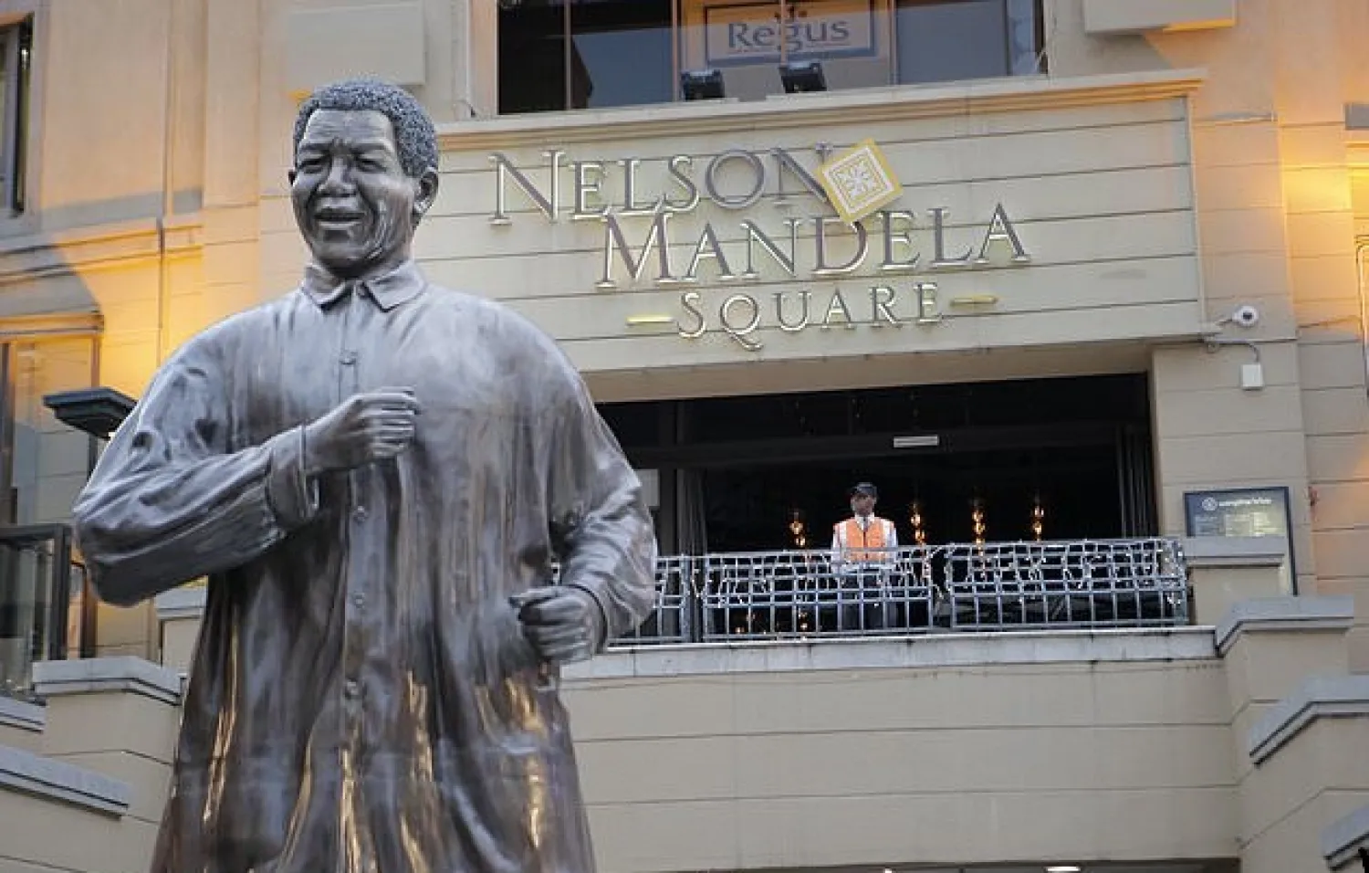 FILE - In this Dec. 12, 2013 file photo, a giant statue of former President Nelson Mandela overlooks Mandela Square in Johannesburg. Mandela's fight for freedom and human rights makes him the most influential person among Africa's youth, according to a survey conducted across the continent. (AP Photo/Tsvangirayi Mukwazhi, File)

