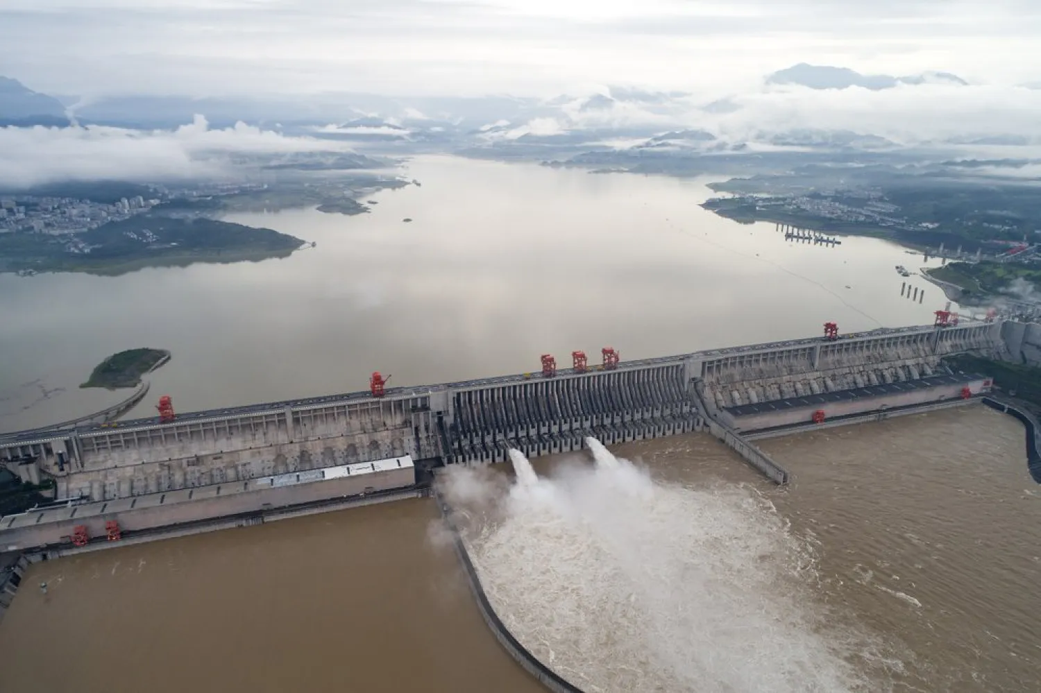 In this photo released by China's Xinhua News Agency, water flows out from sluiceways at the Three Gorges Dam on the Yangtze River near Yichang in central China's Hubei Province, Friday, July 17, 2020. (AP)