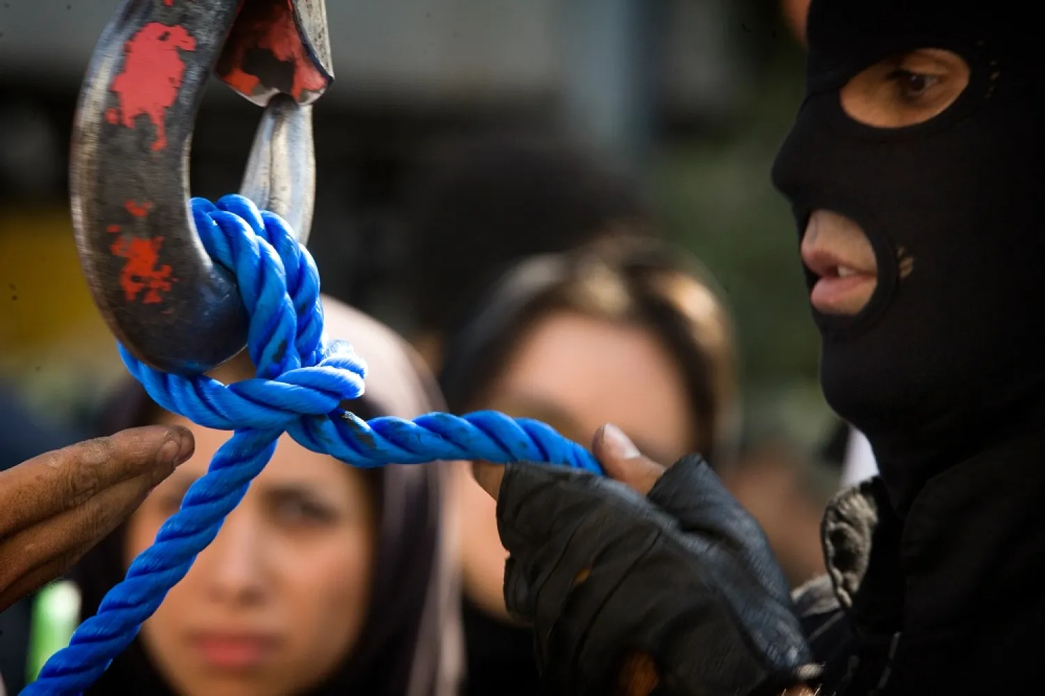 A member of Iran's special police forces checks the rope before an execution by hanging, in Tehran, Aug. 2, 2007. (Reuters)