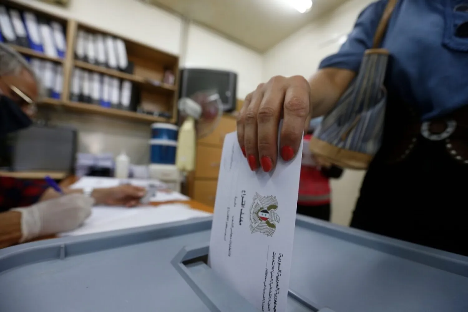 A woman casts her ballot at a polling station in the Syrian capital Damascus on July 19, 2020, during the parliamentary elections. (Getty Images)