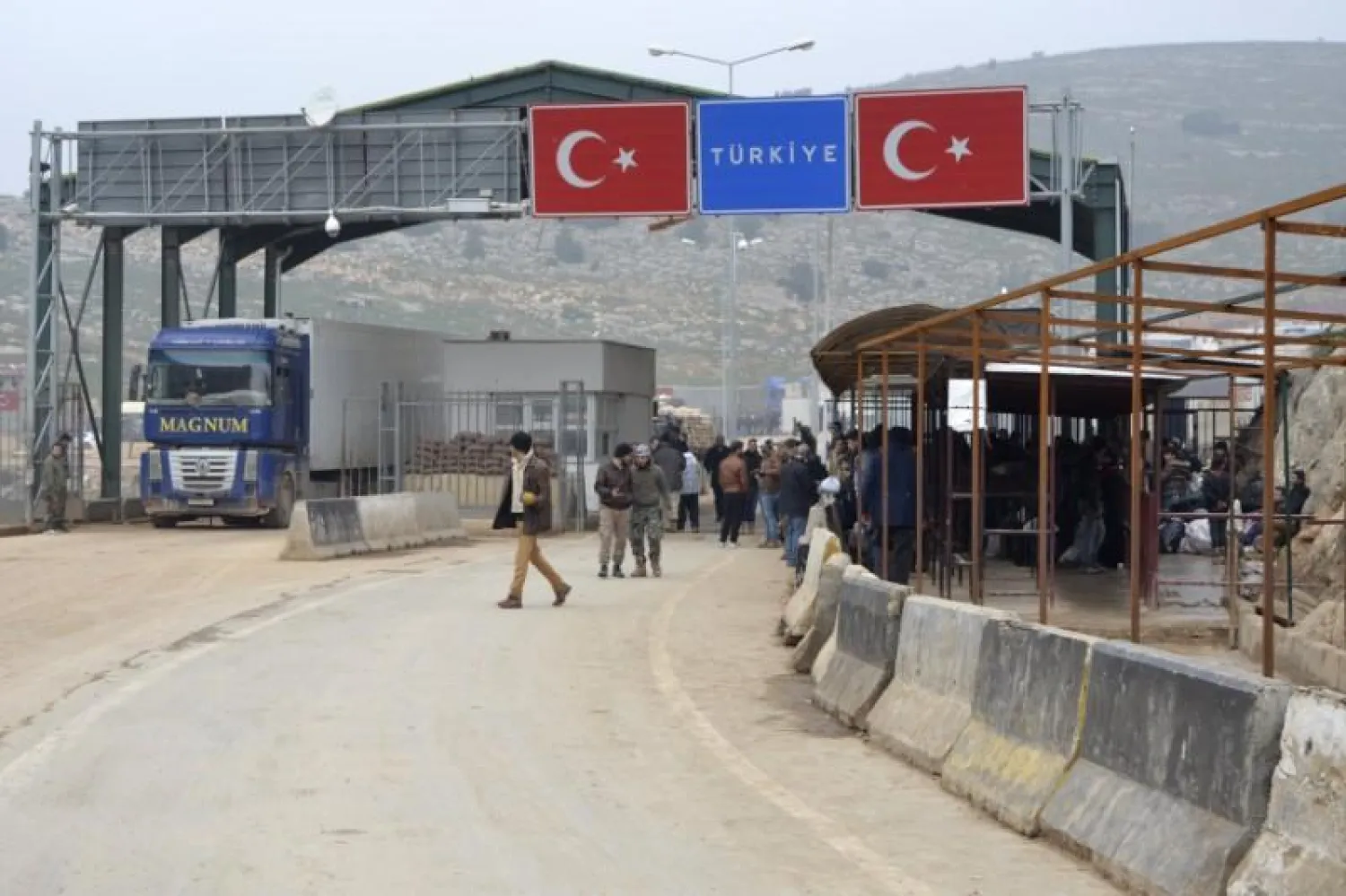 Syrians at a checkpoint at the Syrian border crossing of Bab al-Hawa on the Syrian-Turkish border in Idlib (Reuters)
