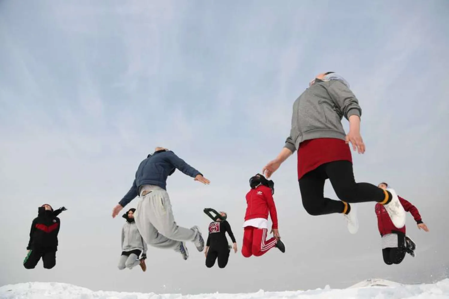Afghan girl members of a Jiu-Jitsu club jump during a practice session on a hilltop in Kabul, Afghanistan, Monday, Jan. 27, 2020, In war-torn Afghanistan gender discrimination has deep cultural and historical roots and many women suffer from domestic violence, jujitsu seems an ideal sport for women, it teaches a person self-defense when faced with a stronger and heavier opponent by using specific techniques, holds, and principles of leverage. Under the Taliban, women were not allowed to go to school, work outside the home or leave their house without a male escort. (AP Photo/Tamana Sarwary)