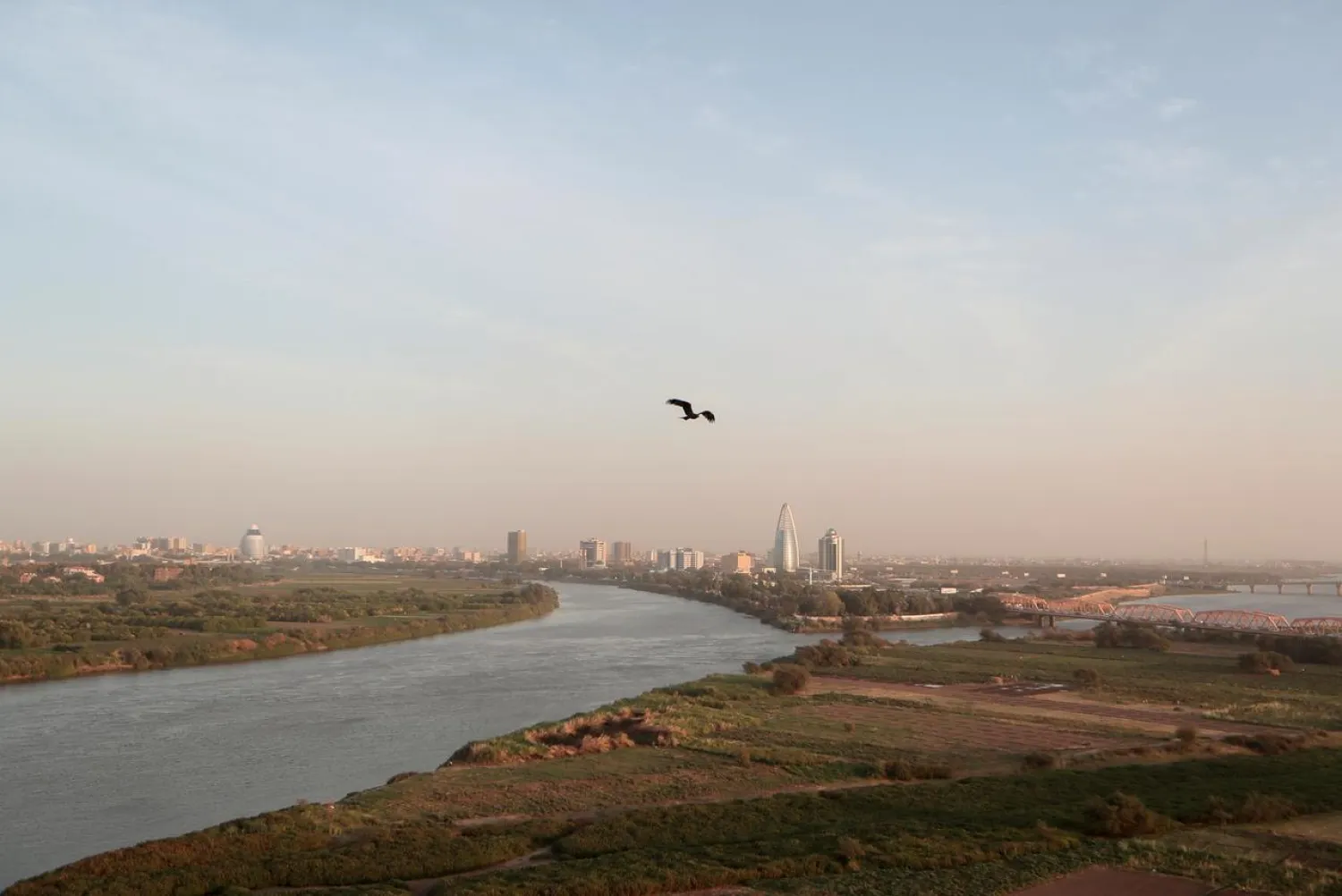 A bird flies over the convergence between the White Nile river and Blue Nile river in Khartoum, Sudan, February 17, 2020. (Reuters)