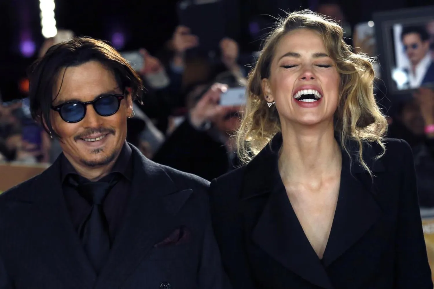 Actor Johnny Depp and girlfriend Amber Heard laugh as they arrive for the UK premiere of 'Mortdecai' at Leicester Square in London January 19, 2015. (Reuters)
