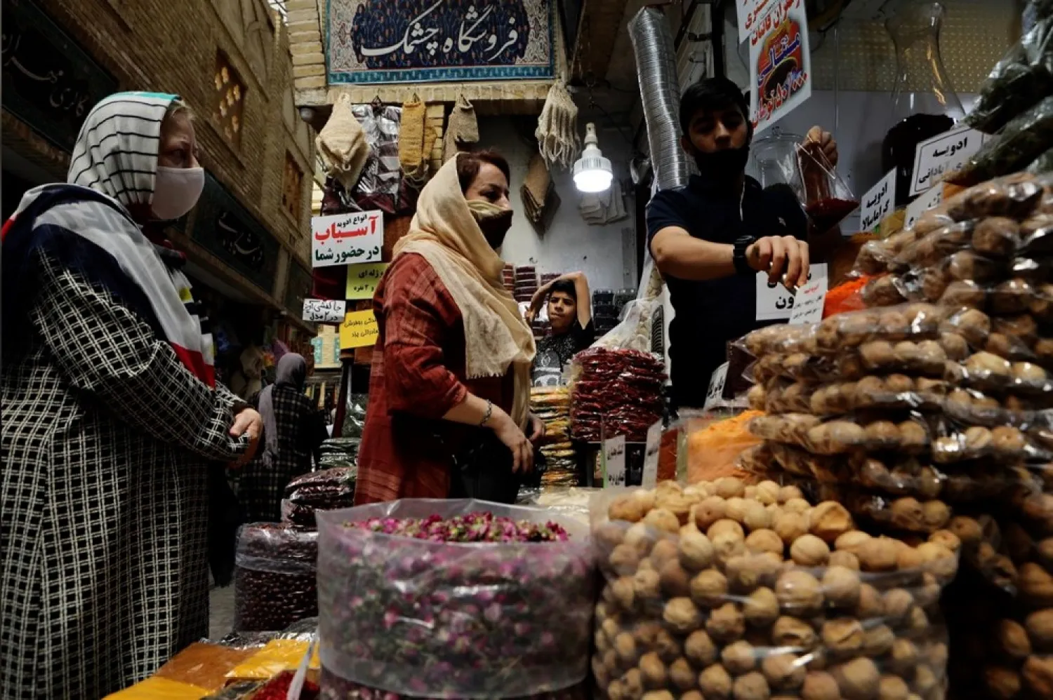 Women wearing protective face masks shop at a bazaar following the outbreak of the coronavirus disease (COVID-19), in Tehran, Iran, July 8. (Reuters)