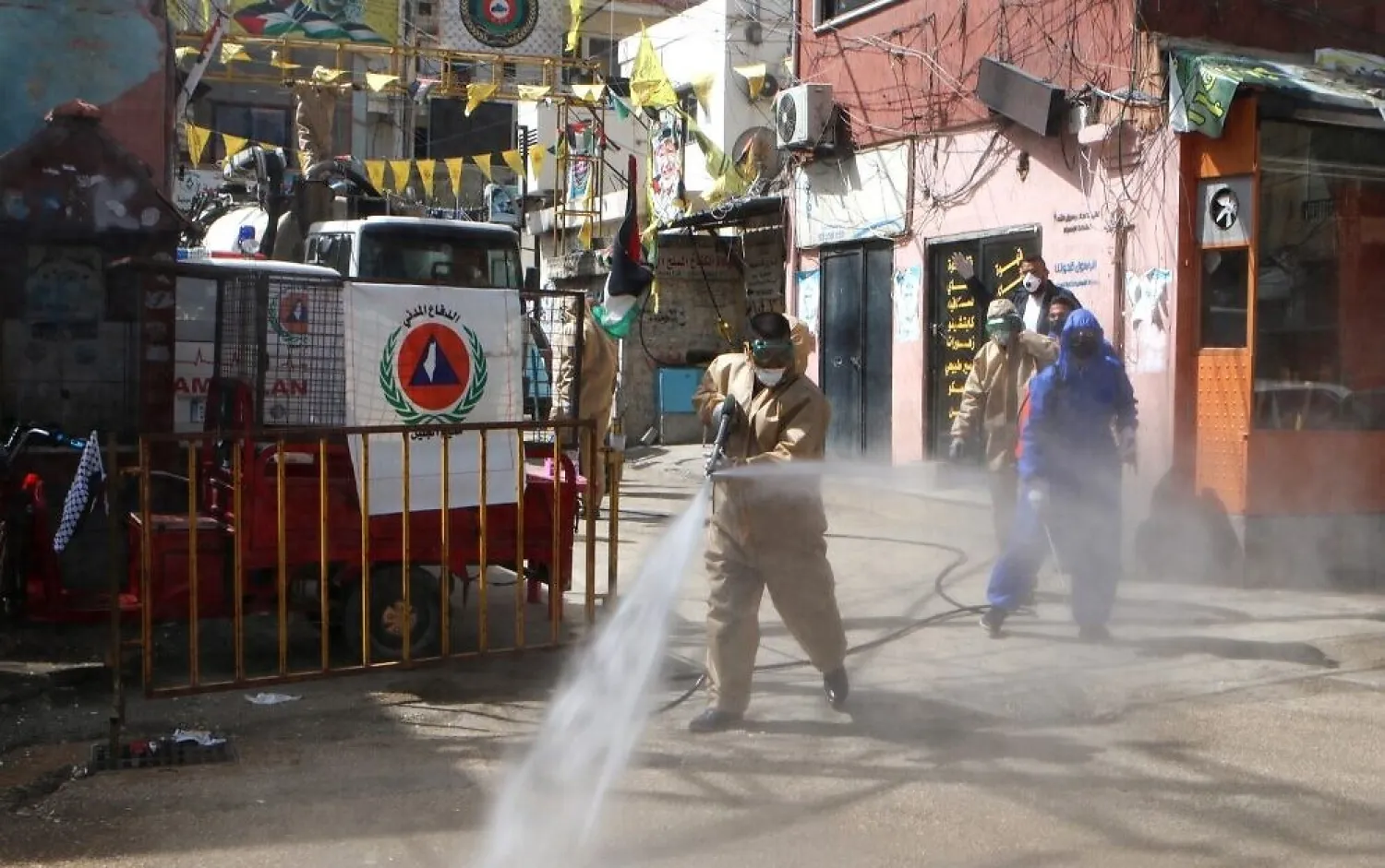 Workers disinfect the Wavel camp for Palestinian refugees in Lebanon's eastern Bekaa Valley, on April 22, 2020, after the UN announced the first confirmed case of coronavirus there. (AFP)