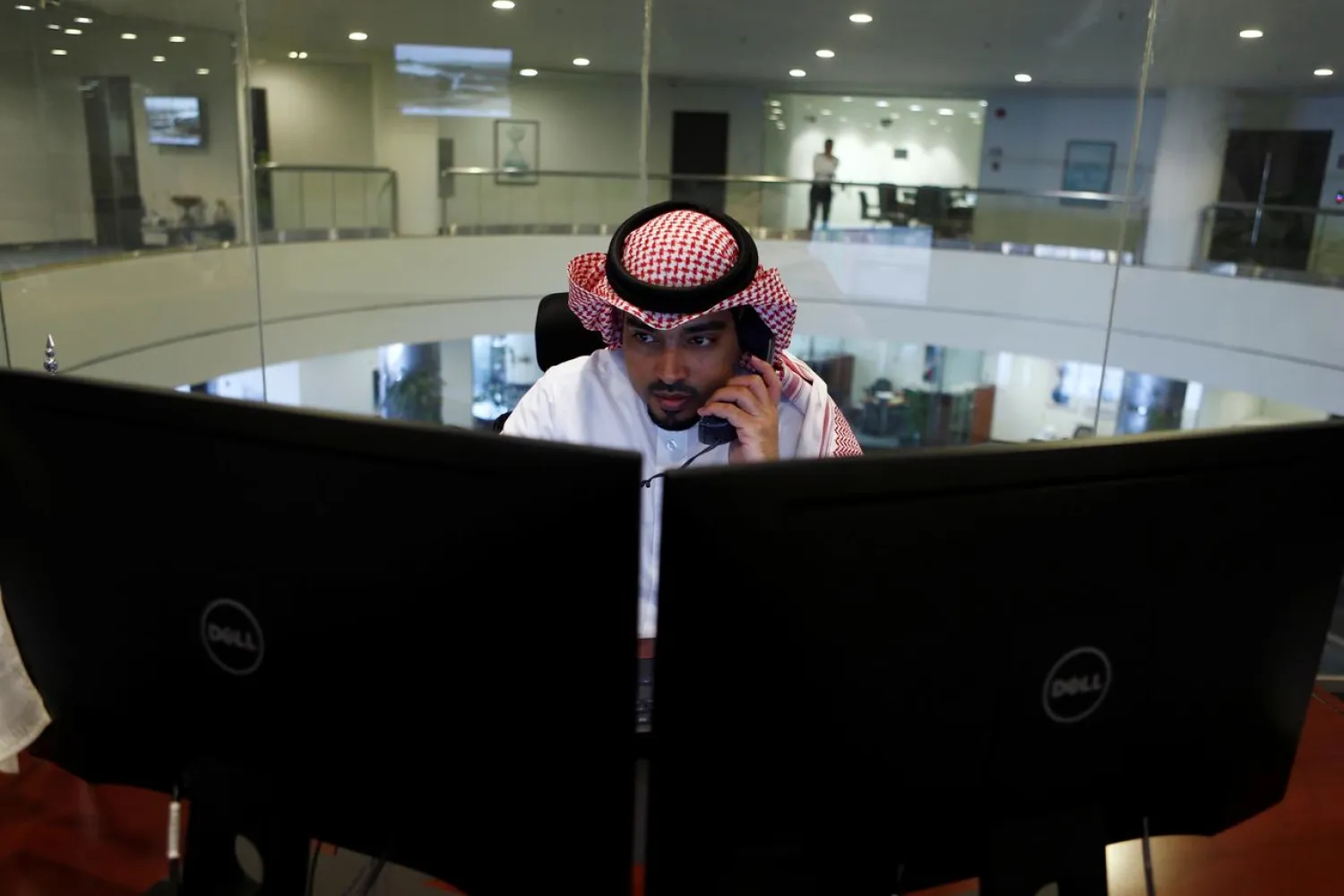 A Saudi trader observes the stock market on monitors at Falcom stock exchange agency in Riyadh, Saudi Arabia. (Reuters)