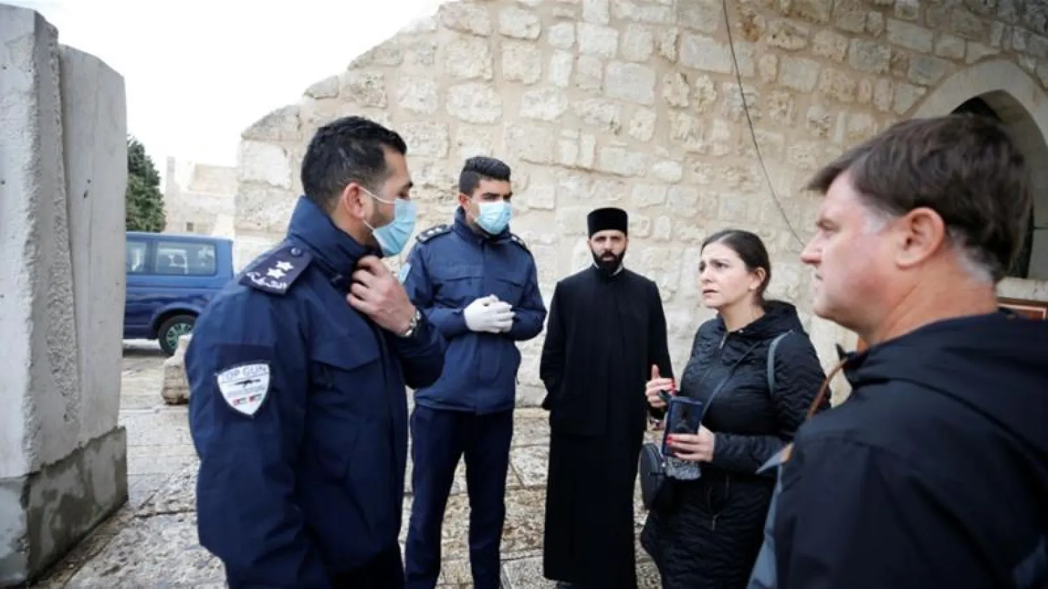 Palestinian police officers in Bethlehem in the West Bank stand guard outside the Church of the Nativity that was closed as a preventive measure against the coronavirus (Reuters)