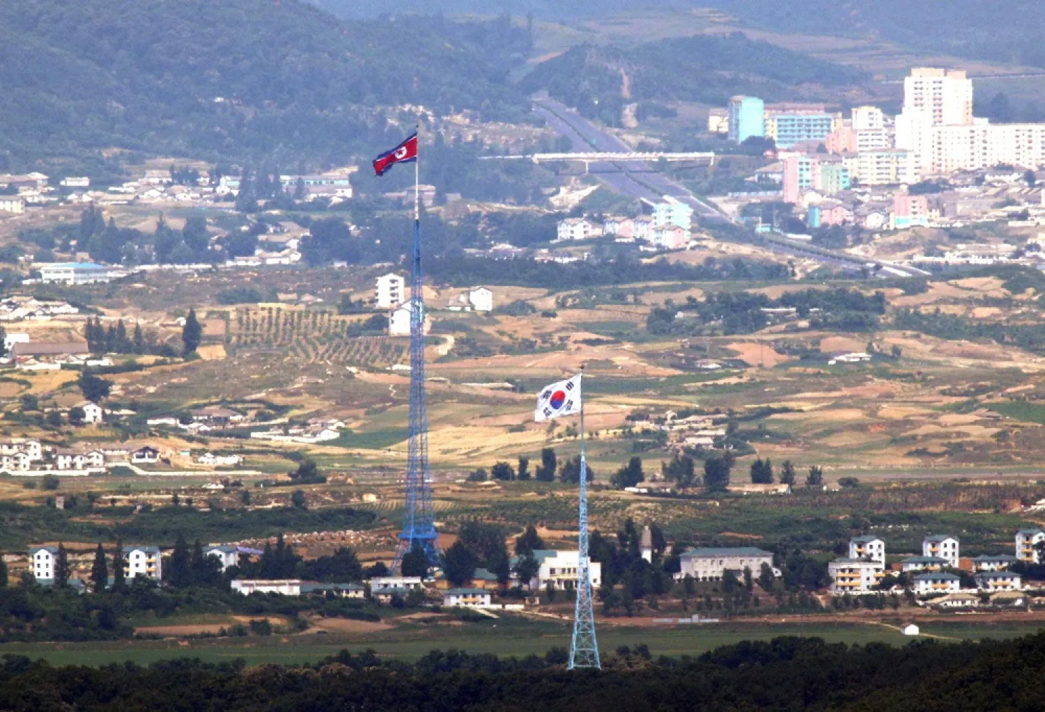 Flags of North Korea, rear, and South Korea, front, flutter in the wind in this photo taken from Paju, South Korea in June. (AP)