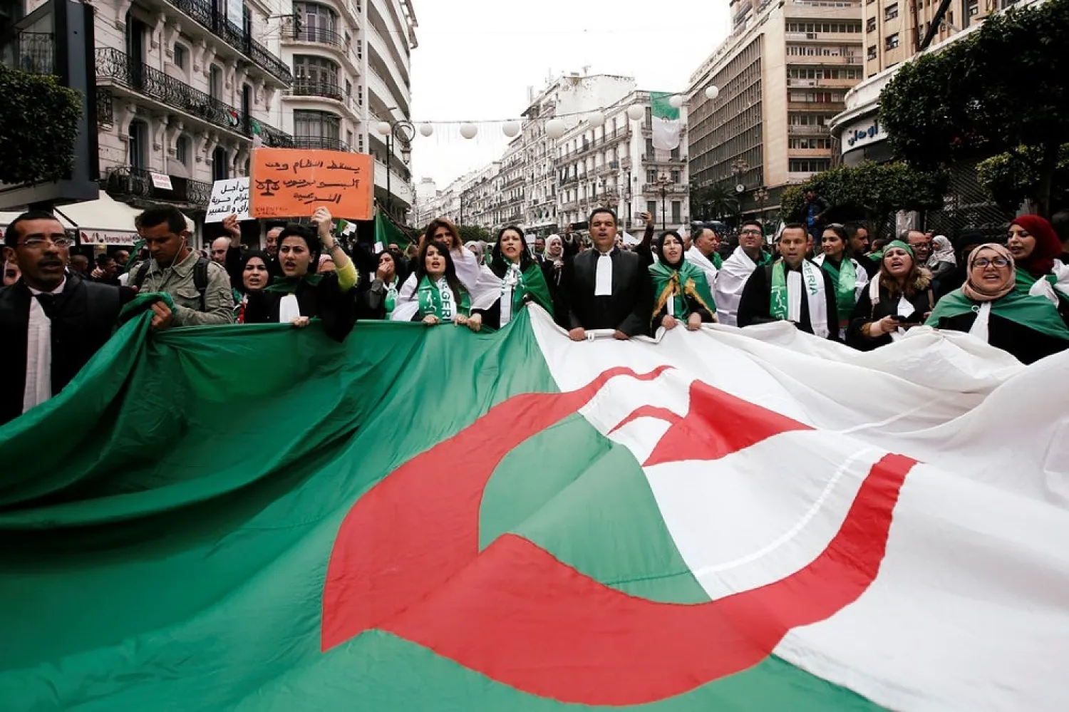 Lawyers carry a national flag as they march during a protest to demand the immediate resignation of President Abdelaziz Bouteflika, in Algiers. (Reuters file photo)