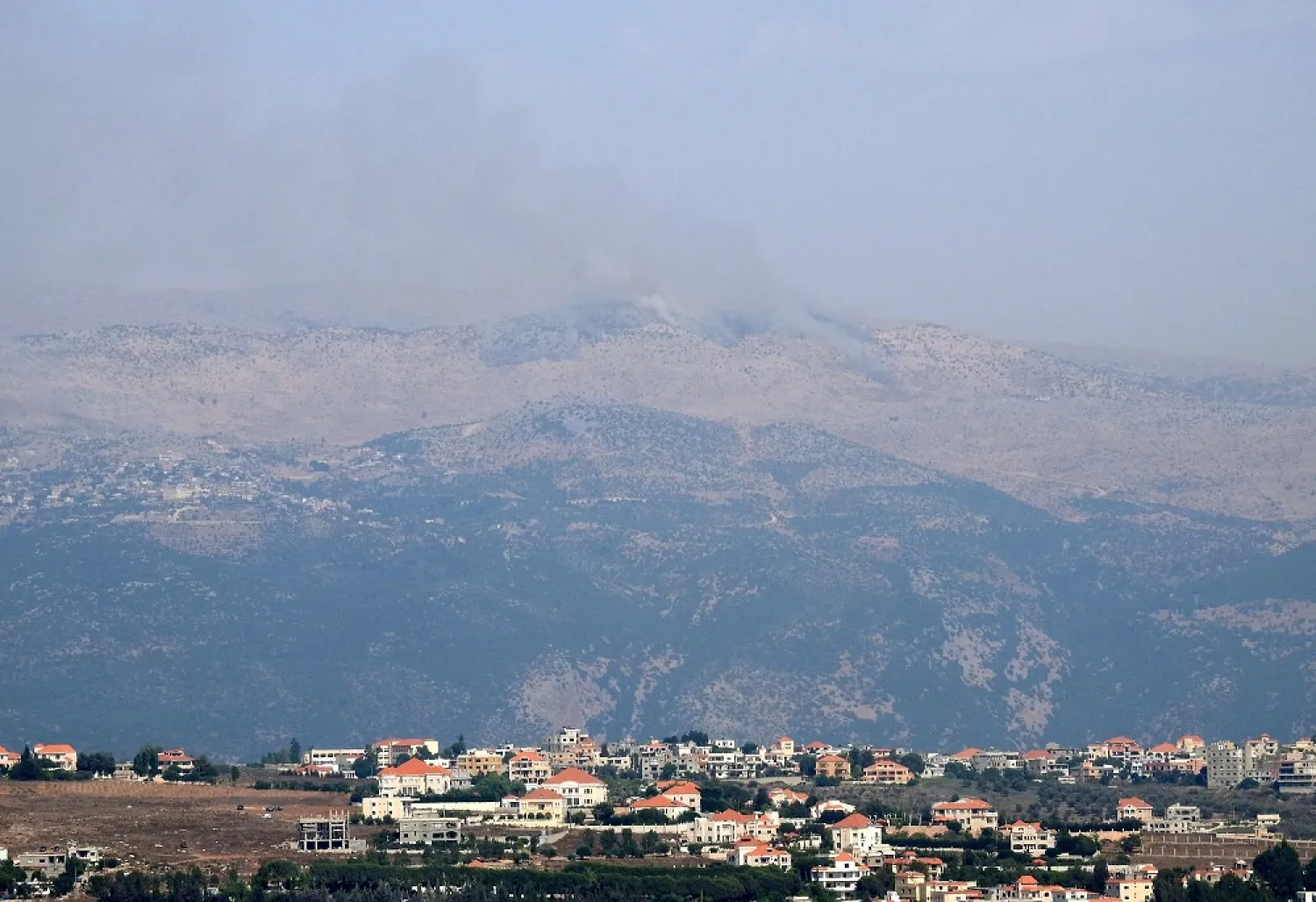Smoke rises from the Shebaa Farms as seen from Marjeyoun village in southern Lebanon, July 27, 2020. (Reuters)