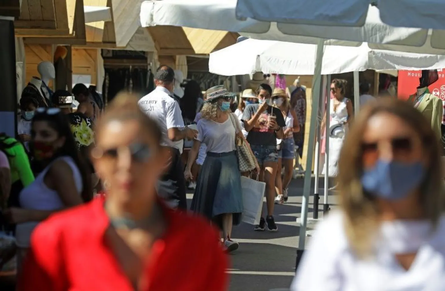 People shop in a commercial area in the upmarket Faqra Club in the Lebanese mountains north of Beirut on July 25, 2020. (Photo by JOSEPH EID / AFP)