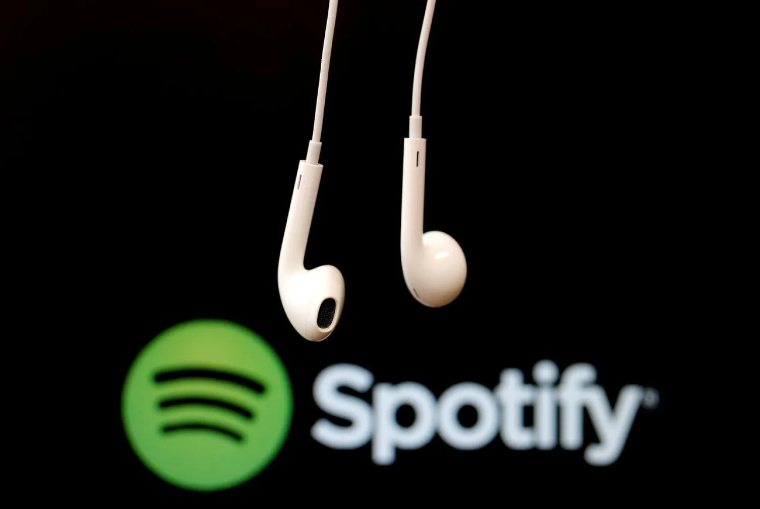 FILE PHOTO: Headphones are seen in front of a logo of online music streaming service Spotify, February 18, 2014 REUTERS/Christian Hartmann/File Photo