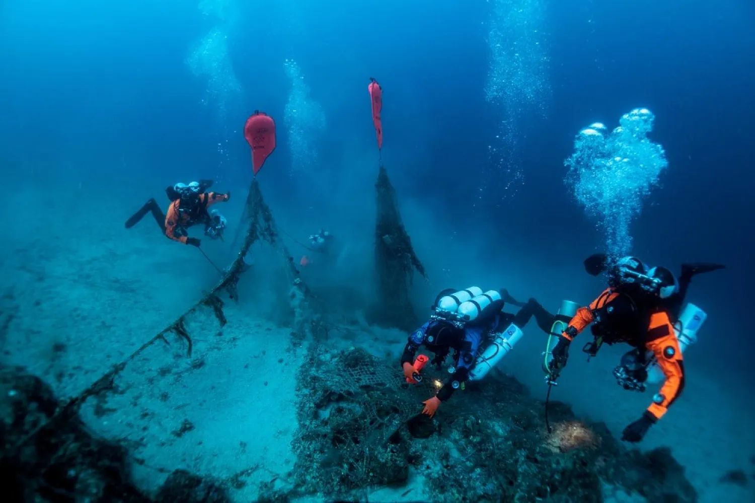 Inflated lifting bags are seen attached to a ghost fishing net as volunteer divers work near the WWII wreck of the HMS Perseus, off the island of Kefalonia, Greece, July 23, 2020. (Reuters)