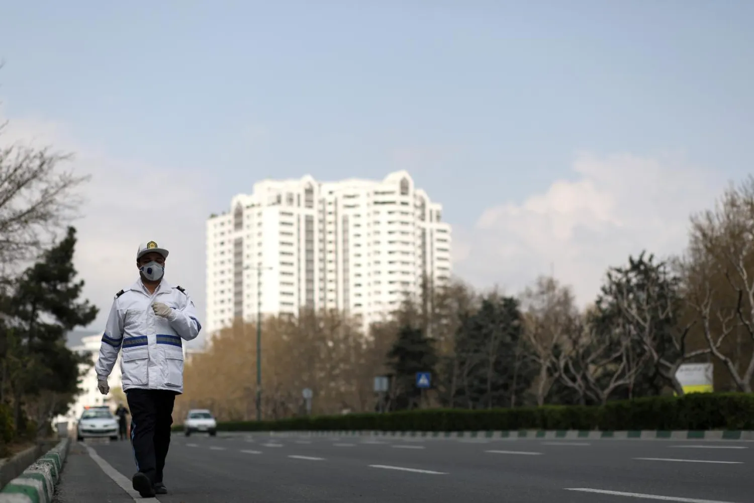 FILE PHOTO: A traffic police officer wears a protective face mask and gloves, amid fear of coronavirus disease (COVID-19), as he walks in Tehran, Iran March 26, 2020. WANA (West Asia News Agency)/Ali Khara via REUTERS