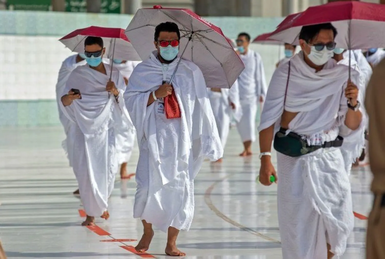 A handout picture provided by Saudi Ministry of Media on July 31, 2020 shows pilgrims circumambulating around the Kaaba. (AFP/HO/Saudi Ministry of Media)
