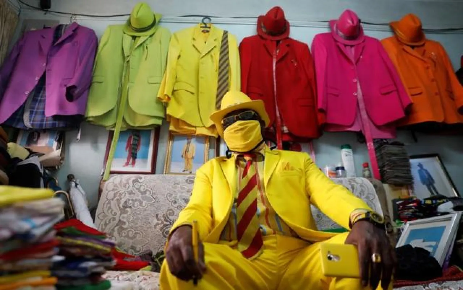 Kenyan fashionista James Maina Mwangi talks during a Reuters interview after displaying his attire comprising at least 160 suits with matching accessories including a mask to prevent the coronavirus disease (COVID-19) infection at his residence in Nairobi, Kenya July 30, 2020. REUTERS/Thomas Mukoya
