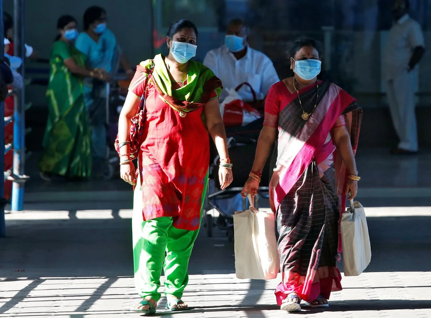 FILE PHOTO: People wearing masks are seen at Chennai International Airport, India, January 30, 2020. REUTERS/P. Ravikumar
