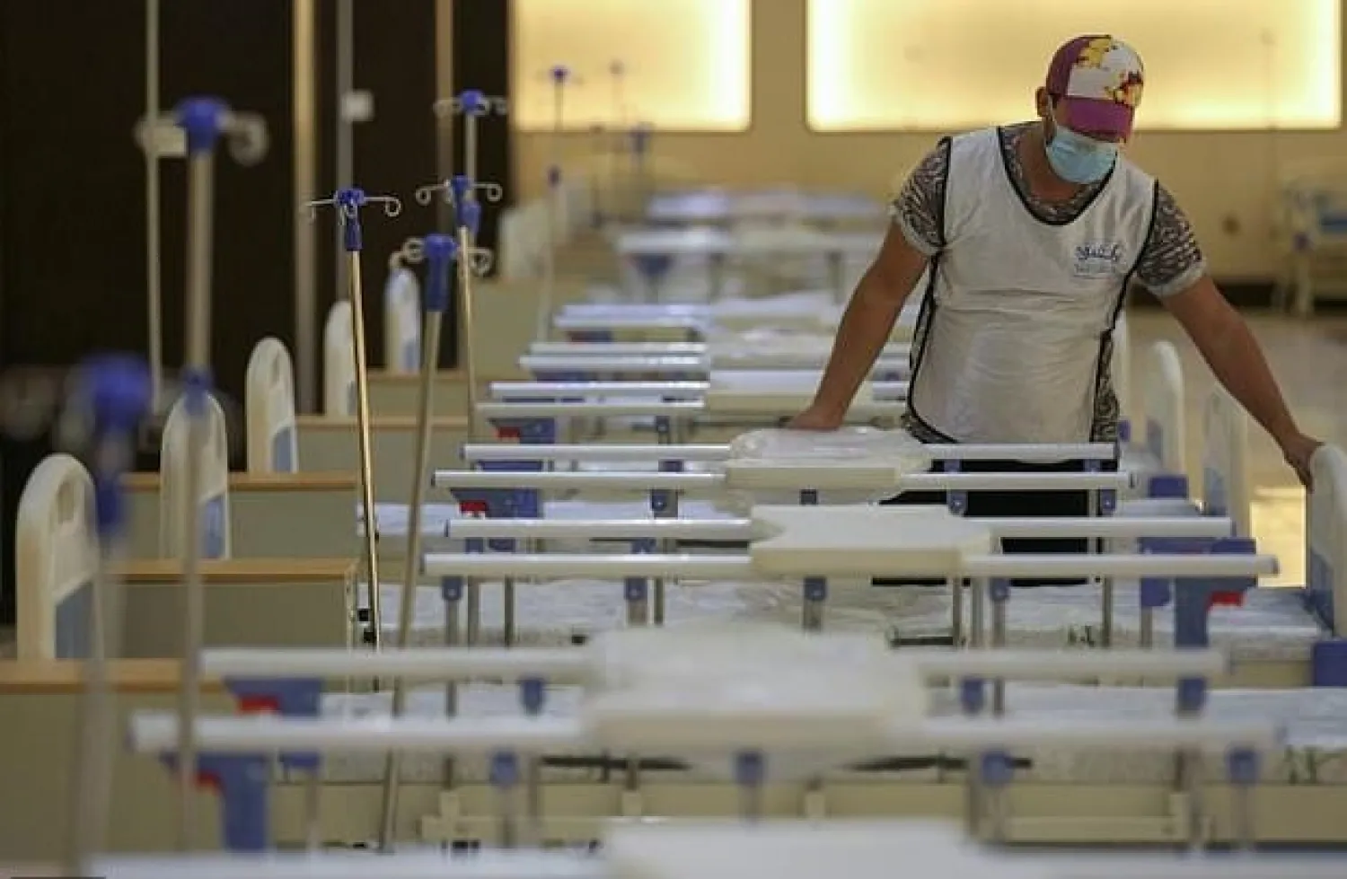 An Iraqi volunteer works on building a 525-bed field hospital at a Baghdad exhibition centre in June to help fight the coronavirus outbreak. AFP
