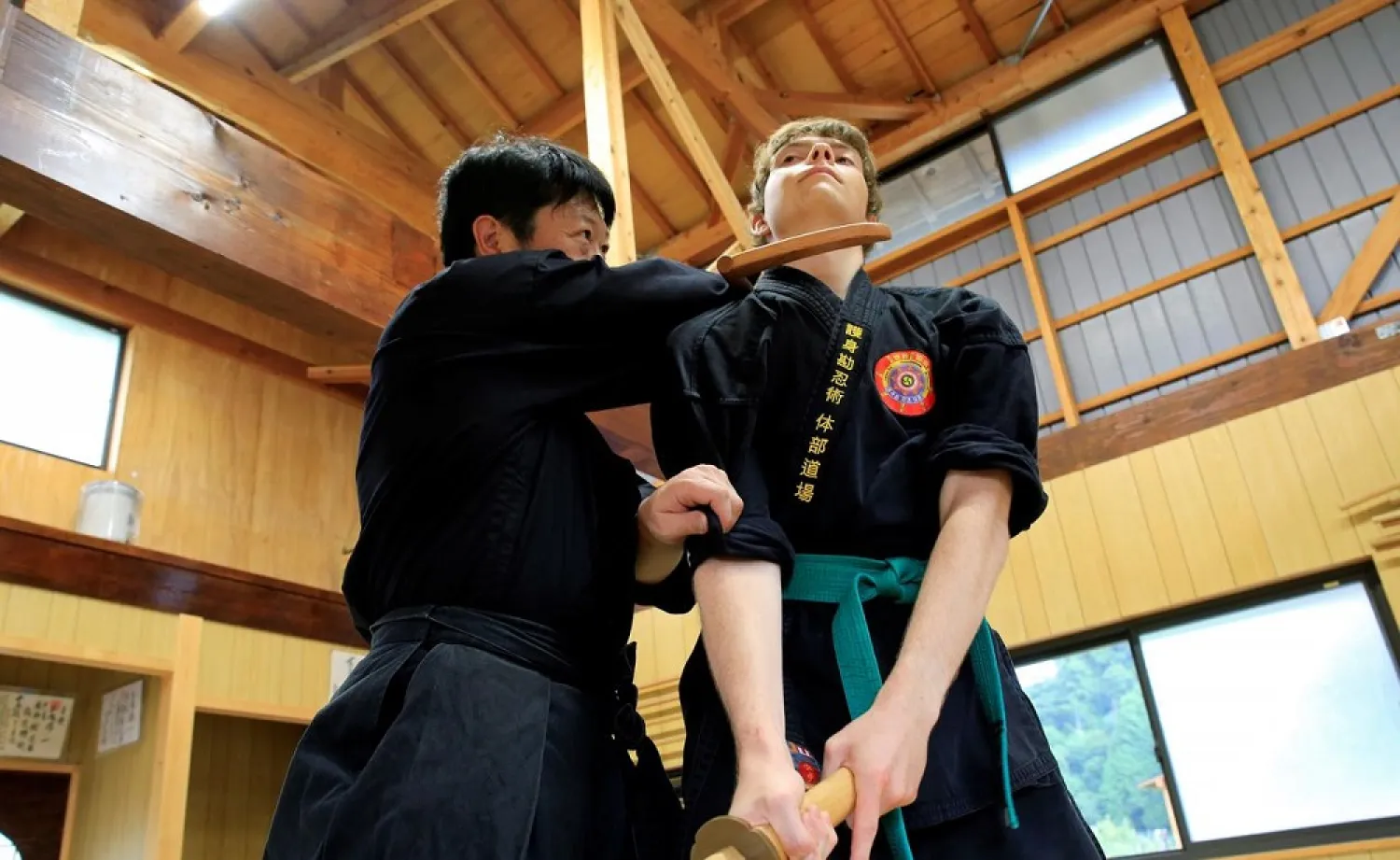 Genichi Mitsuhashi, the first person to hold a degree from Mie University's graduate course on ninja studies, teaches martial arts to a guest in Iga, Mie Prefecture, Japan July 30, 3020. (Reuters)