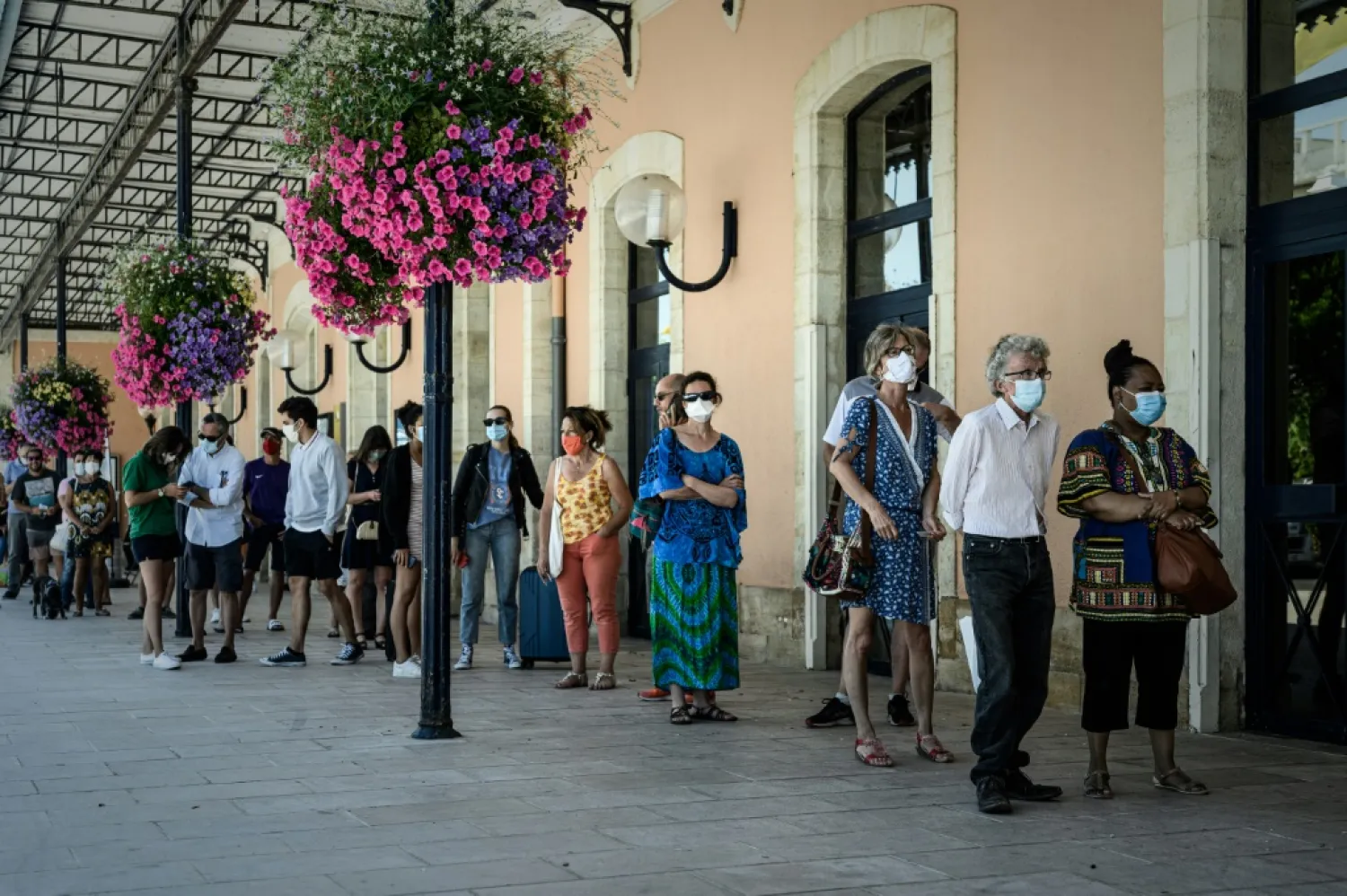 People queue for free COVID-19 testing outside Arcachon railway station in France. (AFP)