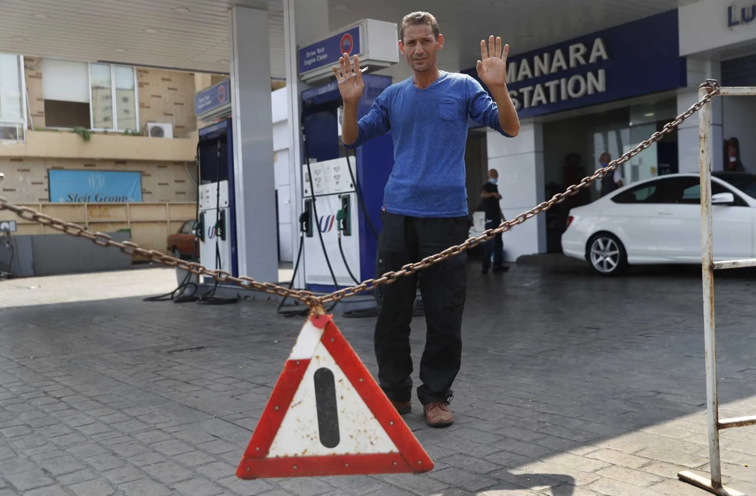 A gas station worker gestures as he saying no fuel at the station, in Beirut, Lebanon, Wednesday, July 29, 2020. (AP Photo/Hussein Malla)