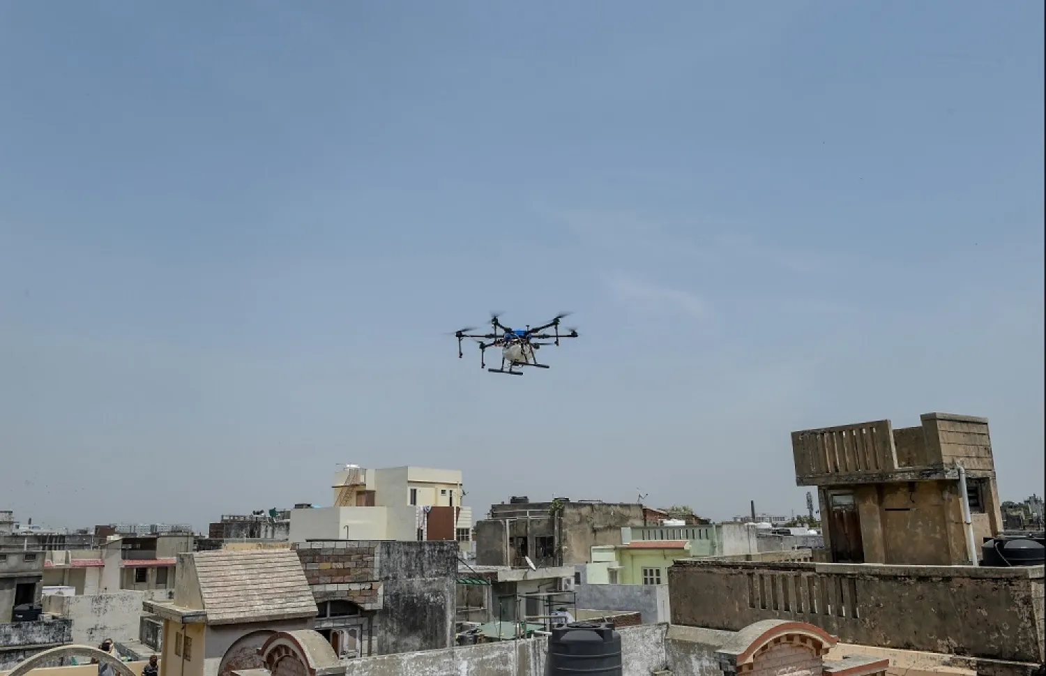 A drone is used to spread disinfectant over residential areas during a government-imposed nationwide lockdown as a preventive measure against the coronavirus, in Ahmedabad, on April 9, 2020. (AFP).