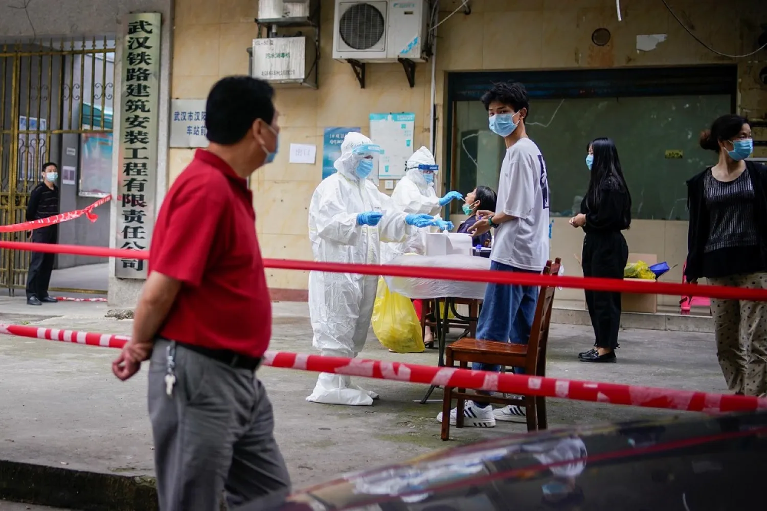 Medical workers in protective suits conduct nucleic acid testings for residents at a residential compound in Wuhan, Hubei province, China May 15, 2020. (Reuters)