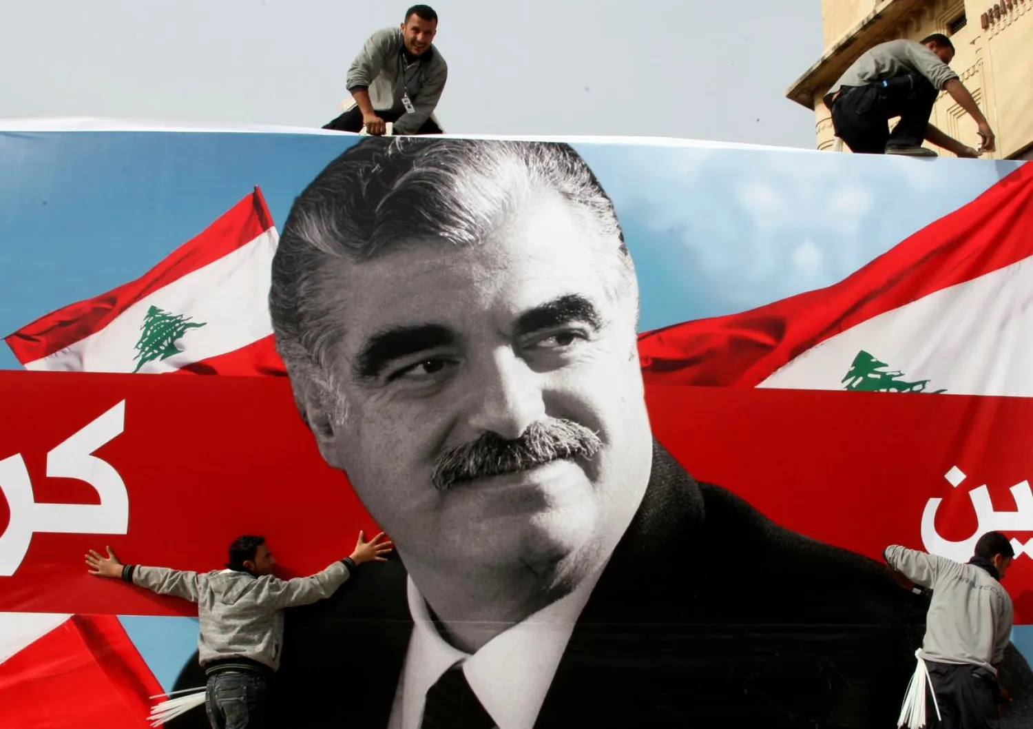 Workers prepare a giant poster depicting Lebanon's assassinated former Prime Minister Rafik al-Hariri, in downtown Beirut, Lebanon February 12, 2010. (Reuters)