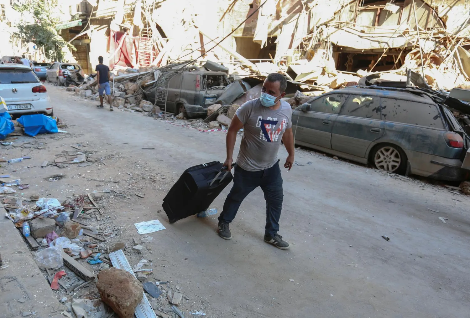 A man pushes his belongings along a street as he evacuates his damaged house, following Tuesday's blast in Beirut's port area, Lebanon August 5, 2020. (Reuters)