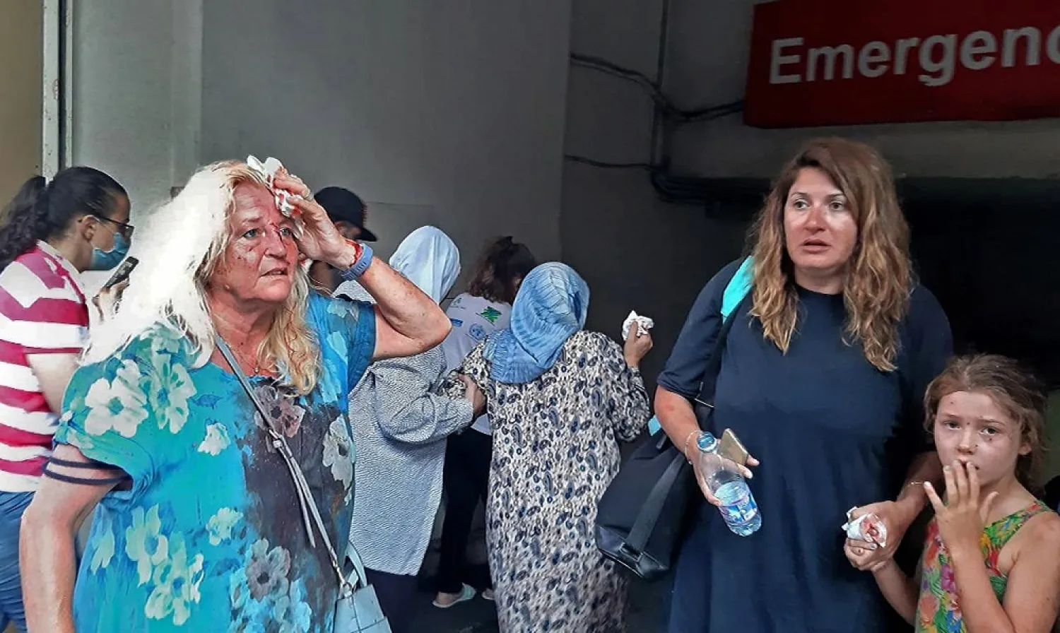 Valarie Fakhoury, a British grandmother with her Lebanese daughter and granddaughter, stand outside the emergency ward of a hospital in the Hamra district of central Beirut. (AFP)