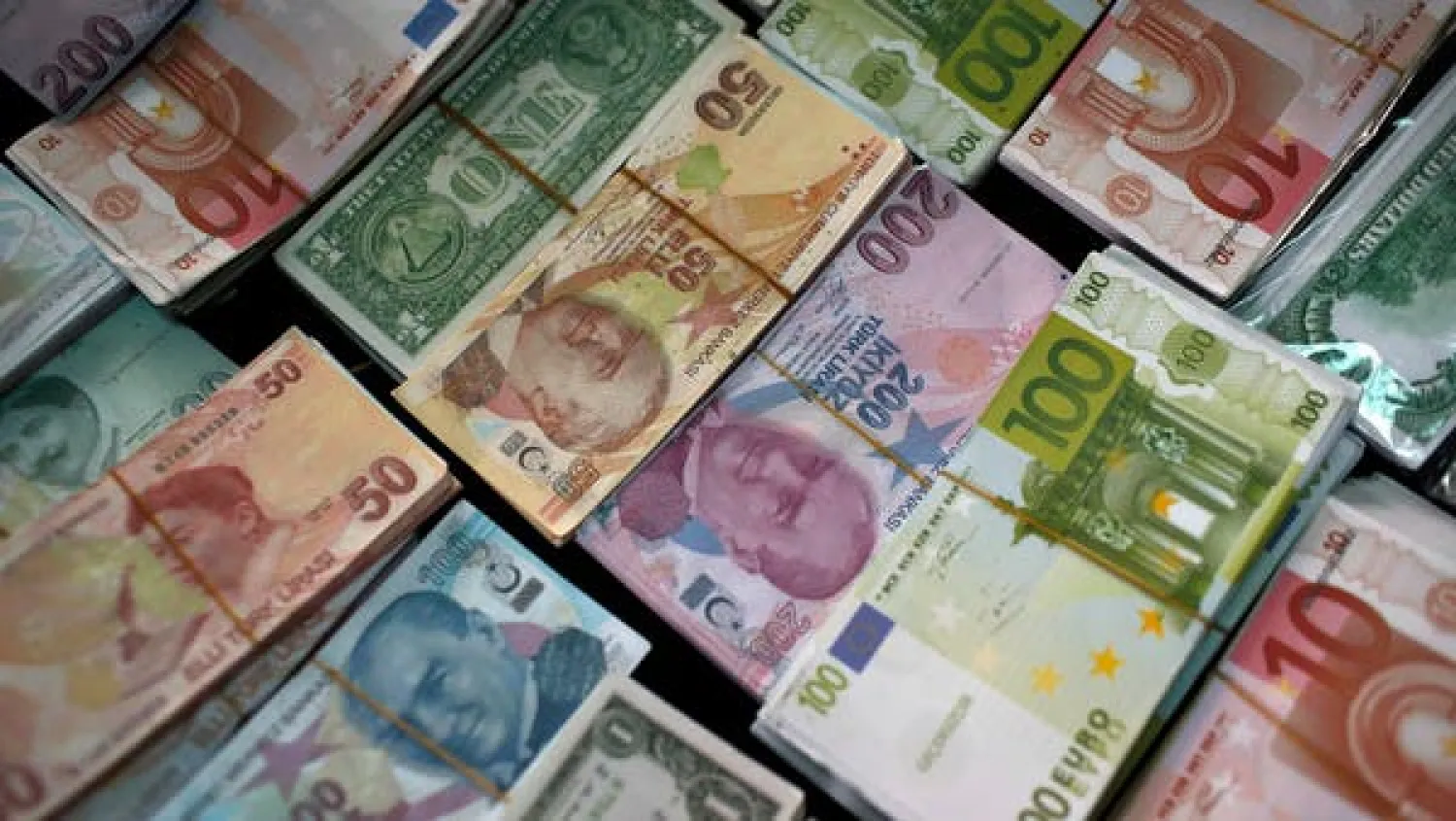 Turkish Liras, centre, featuring images of Turkish Republic founder Mustafa Kemal Ataturk, are seen among other foreign currency, at a currency exchange office in Istanbul, Turkey. (File Photo: AP)
