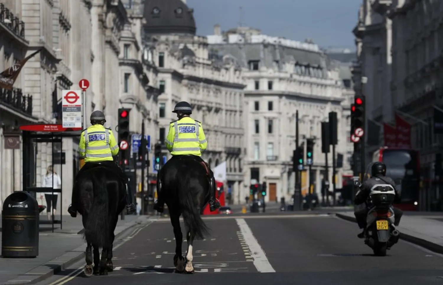 Mounted police officers patrol along a deserted Regent Street in London, as the country is in lockdown to help curb the spread of the coronavirus, Wednesday, April 15, 2020. AP