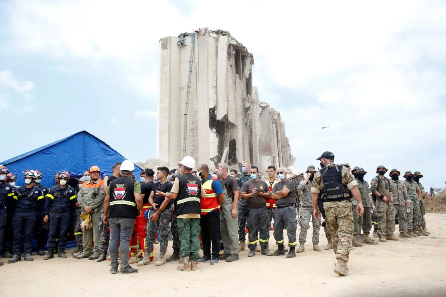 Soldiers and rescue workers stand at the devastated site of the explosion at the port of Beirut, Lebanon August 6, 2020. (Reuters)