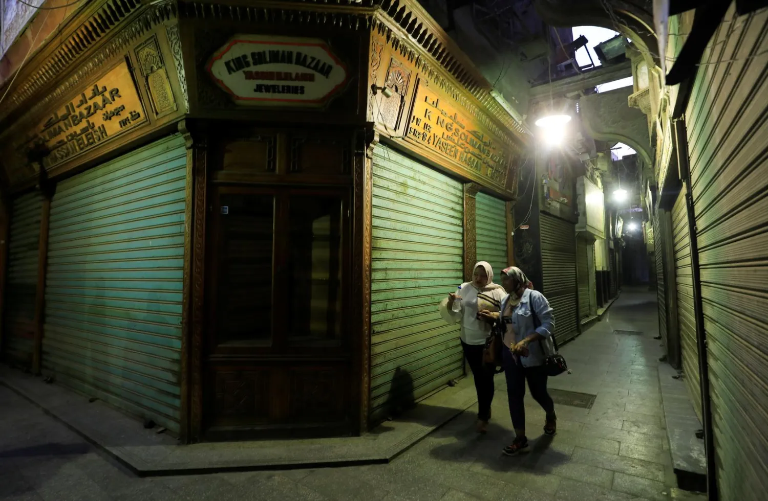 Women walk in front of closed shops at the gold market street following the outbreak of the coronavirus disease (COVID-19), in old Cairo, Egypt July 26, 2020. REUTERS/Amr Abdallah Dalsh
