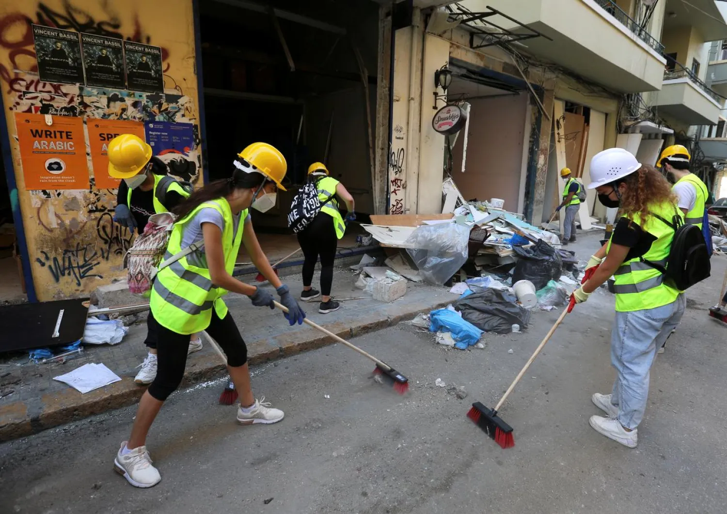 Volunteers clean debris from the street following Tuesday’s blast in Beirut Port, Lebanon, August 7, 2020. Reuters
